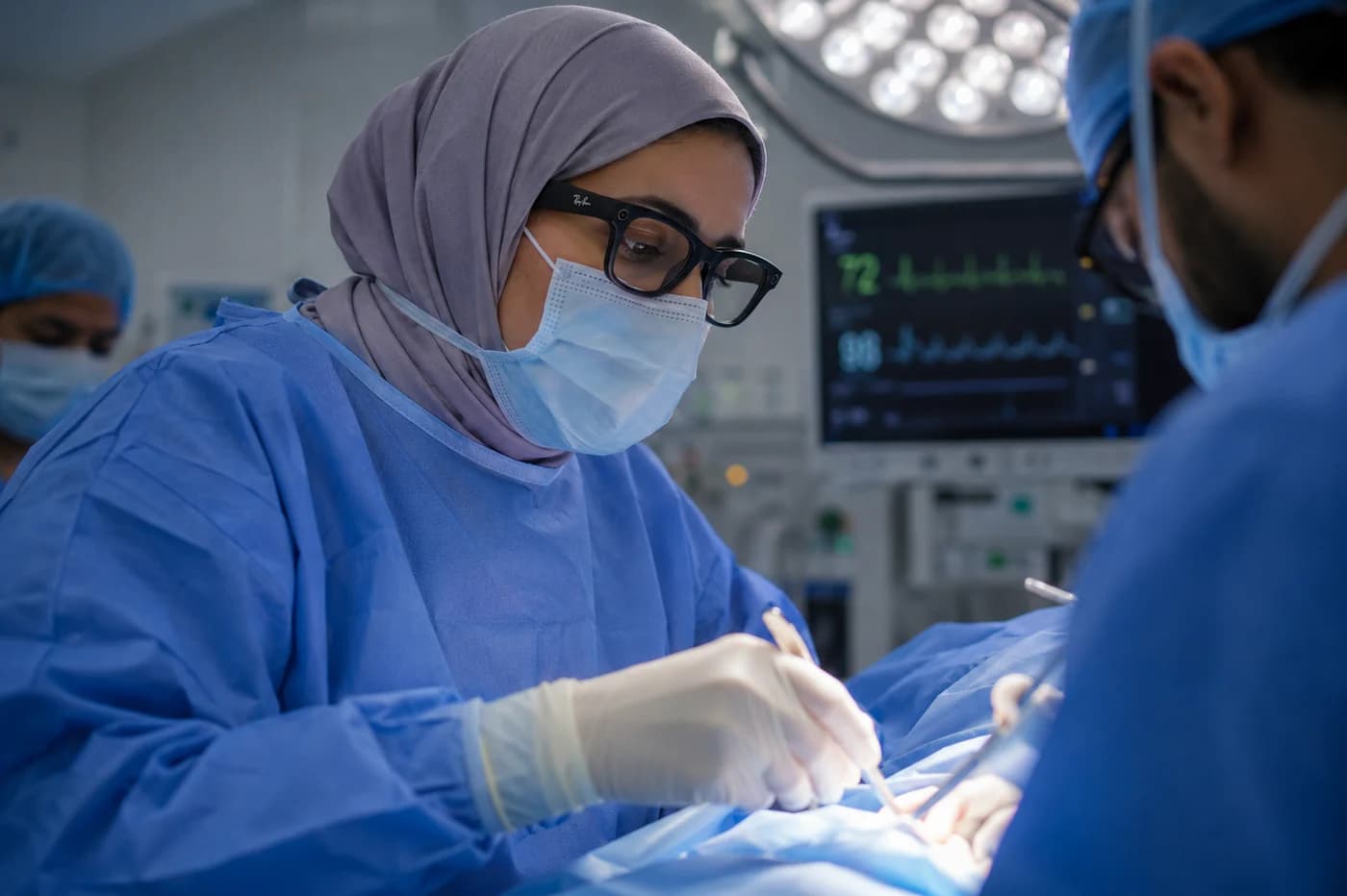 A surgeon wearing Meta AI glasses during a procedure in an operating room